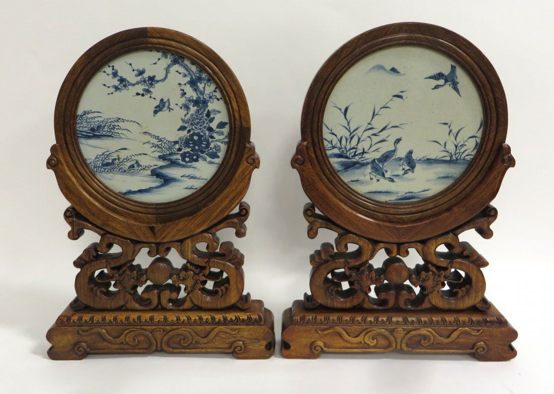 Pair Table Screens: A pair of table screens with fine antique blue and white round inserts. The more recently made stands are later in date. 21 1/2" tall. Shipping: We are able to pack and ship this item to an address in
