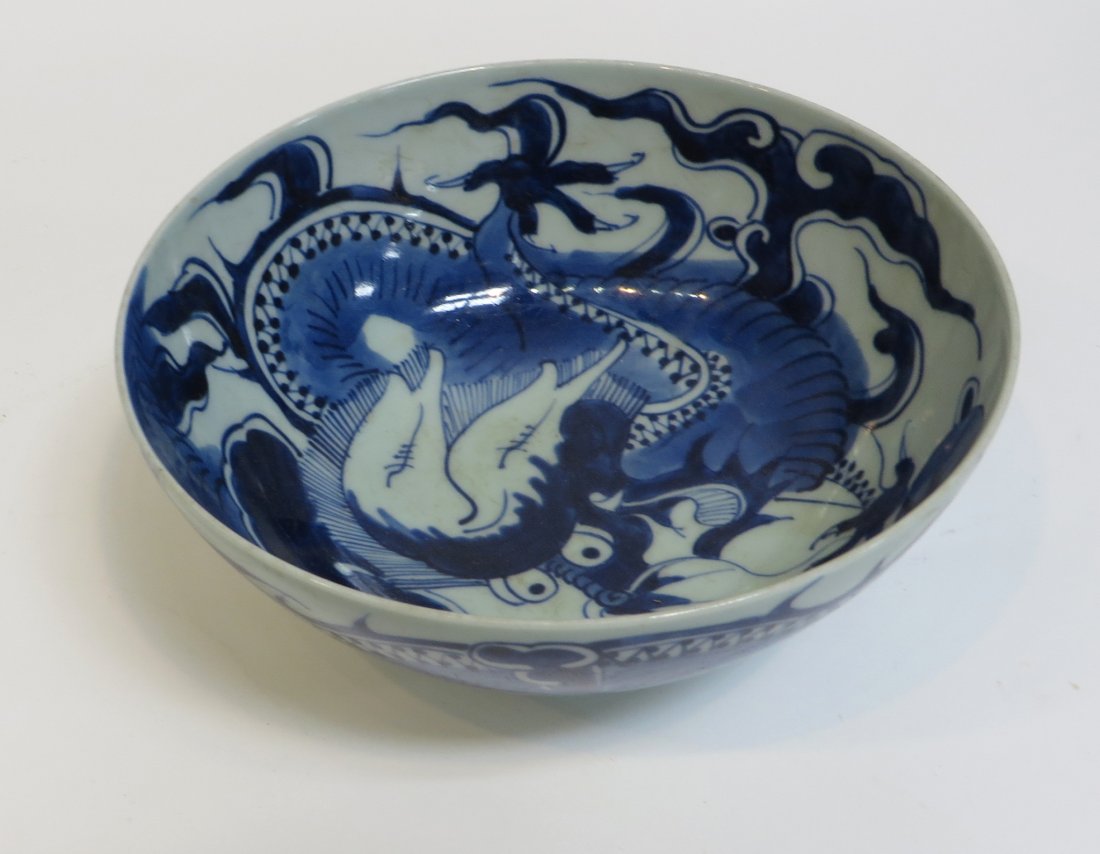Porcelain Bowl: A 7 1/2" blue and white glazed bowl with a strong dragon image whose torso swirls about the exterior going over into the interior to show his head. Unusual mark at the bottom Shipping: We are able to 