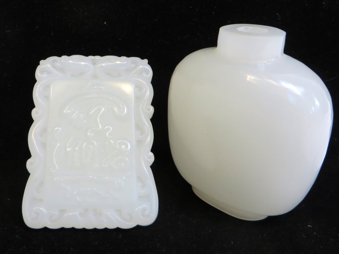 Two White Jade Items: A 3" snuff bottle, lacking the top and a rectangular 2 3/4" X 2" pendant with carved calligraphic symbols. Shipping: We are able to pack and ship this item to an address in the United States for $25.0