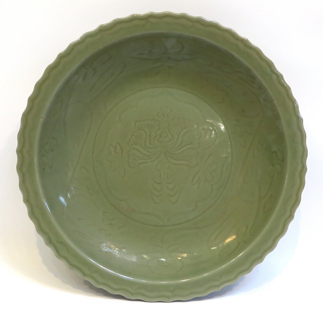 Longquan Style Celadon Charger: 16 1/4", with embossed design in jade toned green. No mark. Shipping: We are able to pack and ship this item to an address in the United States for $50.00 via USPS Priority Mail or via FedEx Ground/Ho