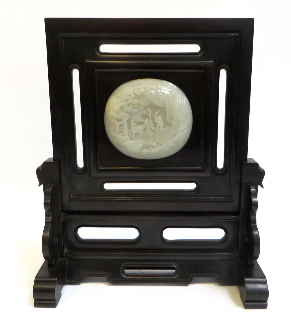 Chinese Rosewood Screen: A 15" high rosewood screen with a mounted Jadeite oval disk carved with a hunting scene. Shipping: We are able to pack and ship this item to an address in the United States for $50.00 via USPS Priorit