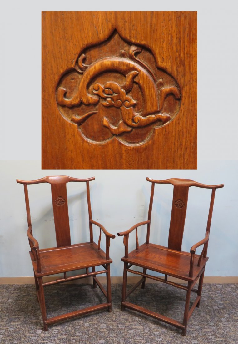 Pair Of Huanghuali Arm Chairs: In the classic Chinese style of the 19th century, with gently curving armrests back rests and rounded legs. Cane seating panels. Shipping: We are unable to ship this item. Please contact our local UPS