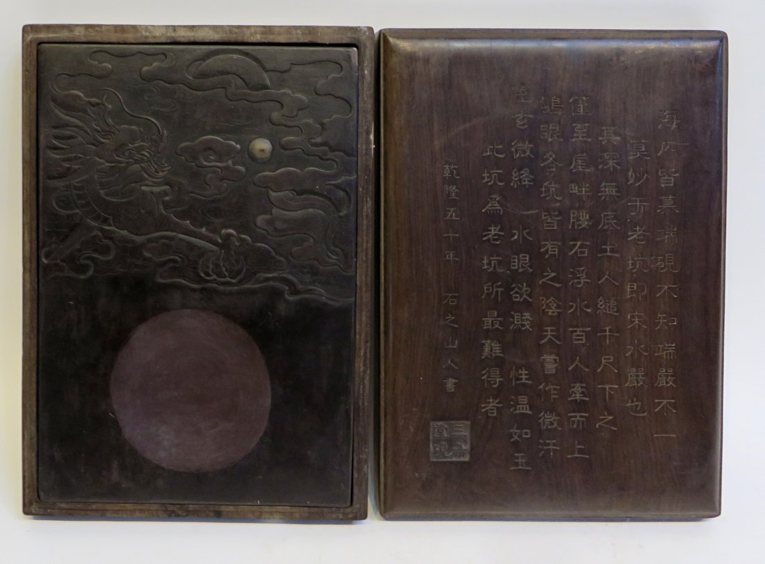 Massive Duan Inkstone In Box: A massive 14 3/4" inkstone with a whimsical dragon, pearl and carved encasement with calligraphy. 11" wide. There are five interesting inkstones in this sale, lots 12, 22, 28, 38, and 41. We have done