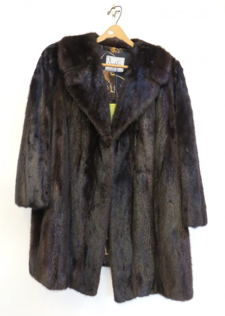 Ladies Mink Coat: In black with lion print in the lining, measuring sleeve length 23 1/2", across the back, 20"; overall length 29". Shipping: We are able to pack and ship this item to an address in the United States f