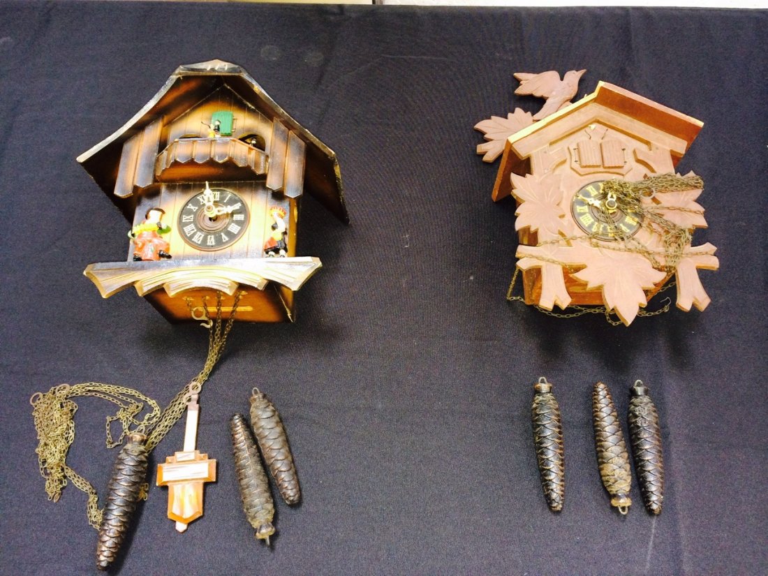 Two Cuckoo Type Clocks: Two three weight cuckoo clock, with music or automata. . Shipping: We are able to pack and ship this item to an address in the United States for $50.00 via USPS Priority Mail or via FedEx Ground/Home 