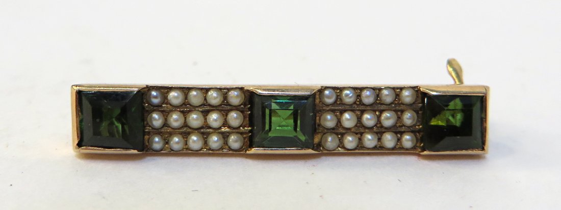 Bar Pin: A 30mm 14K gold bar piin set with tiny seed pearls and square cut green stones, possibly emeralds Shipping: We are able to pack and ship this item to an address in the United States for $15.00 via USP