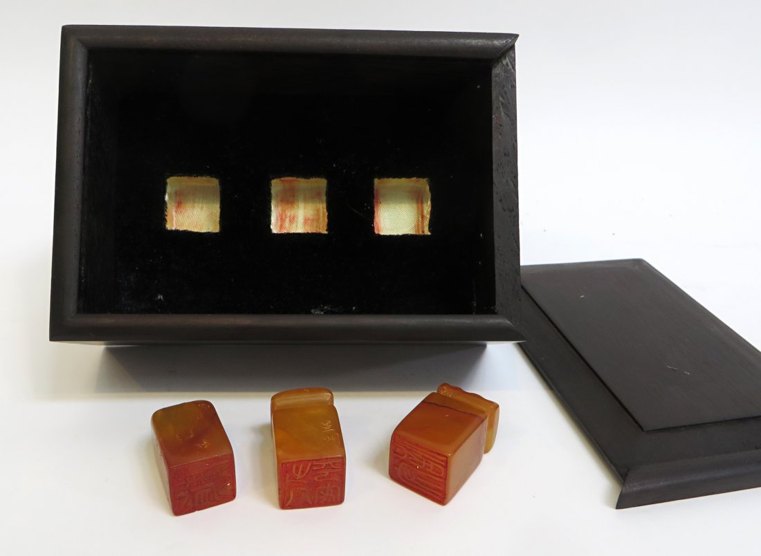 Three Tianghuang Seals: Three red stoned seals in a fitted rosewood box. Shipping: We are able to pack and ship this item to an address in the United States for $25.00 via USPS Priority Mail. Tracking information will be sen