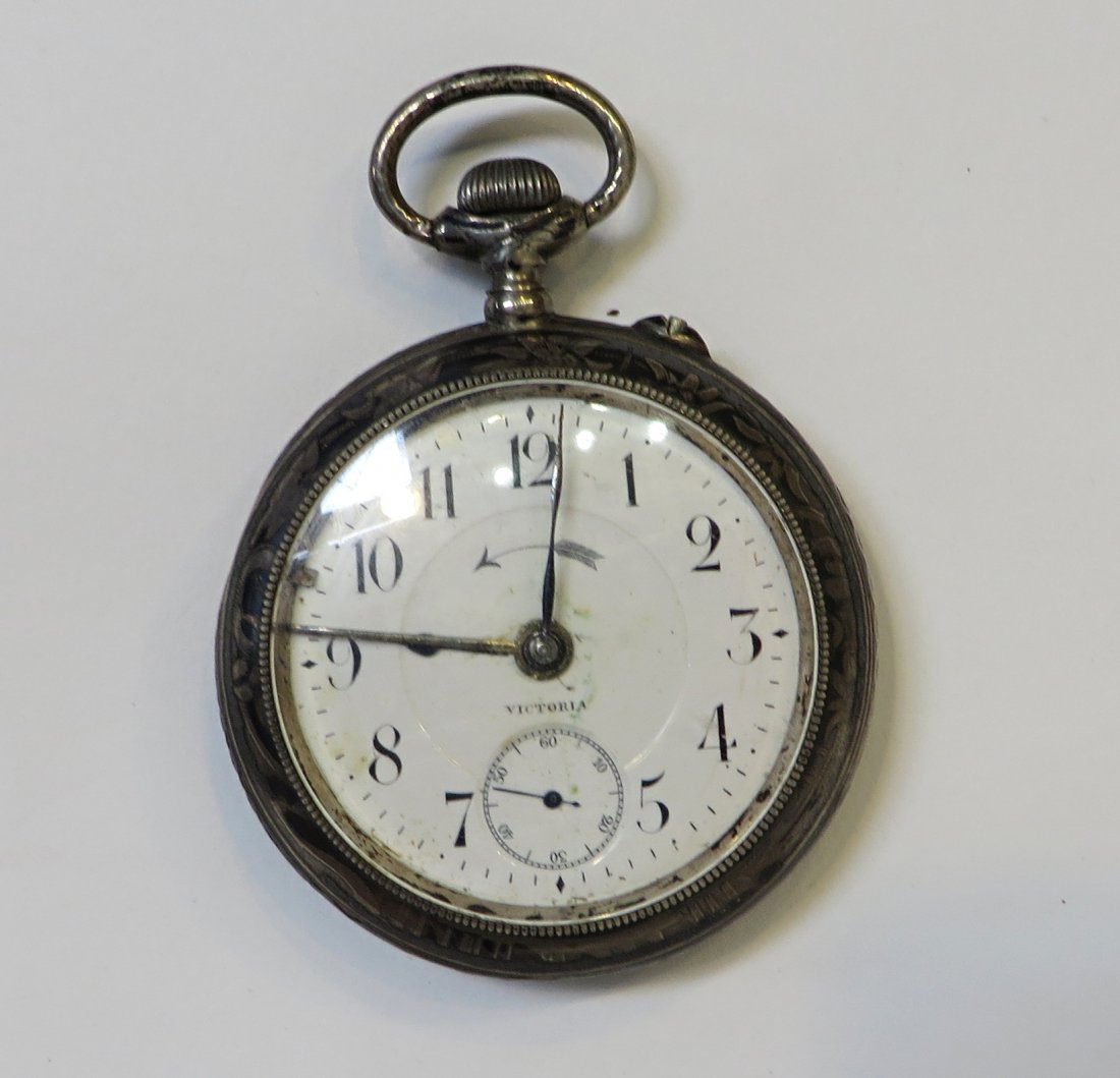 Niello Silver Cased Watch: An alarm watch in a Niello case. The case, worn, may be illustrating the sport of mountaineering, with an easel form back cover and am alarm mechanism. The French or Swiss watch signed on the dial Vic