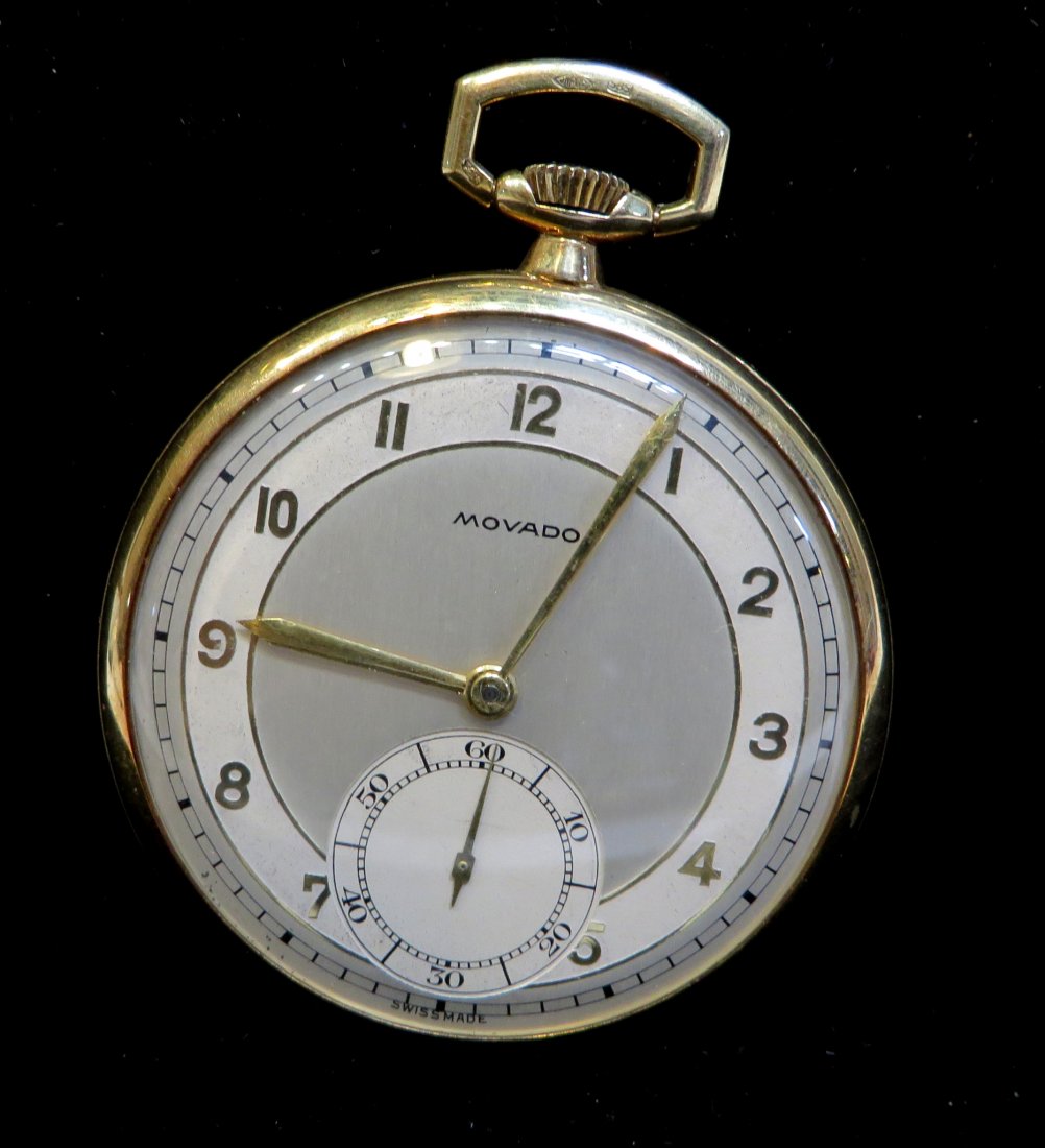 Movado Gold Men's' Dress Watch: A 14K gold dress watch engraved on the back in the Art Deco style with gold hands and gold numerals applied onto the metal engraved dial. Shipping: We are able to pack and ship this item to an address