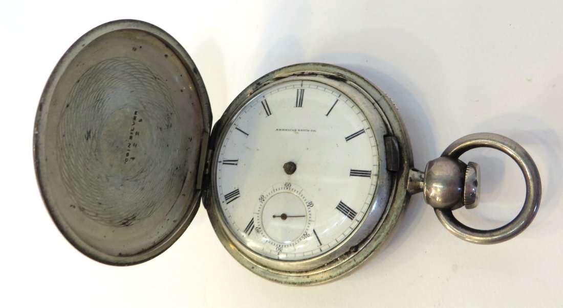 American Watch Pocket Watch: A coin silver hunting cased mens pocket watch with an American 19th C. 18 size key wind pocket watch, #646633. The jeweled watch probably needing cleaning and oiling, and lacking both minute and hour 