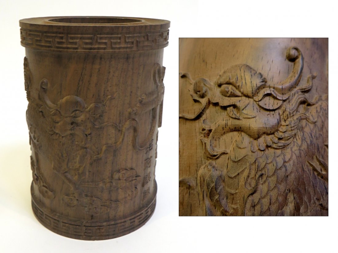 Chen Xiang Brush Pot: A solid hardwood bas relief carved brush pot featuring a pair of Chimera Qilit flanking a calligraphic slogan. Exceptionally carved but of recent age. Approximately 6" tall and very dense. Shipping: W