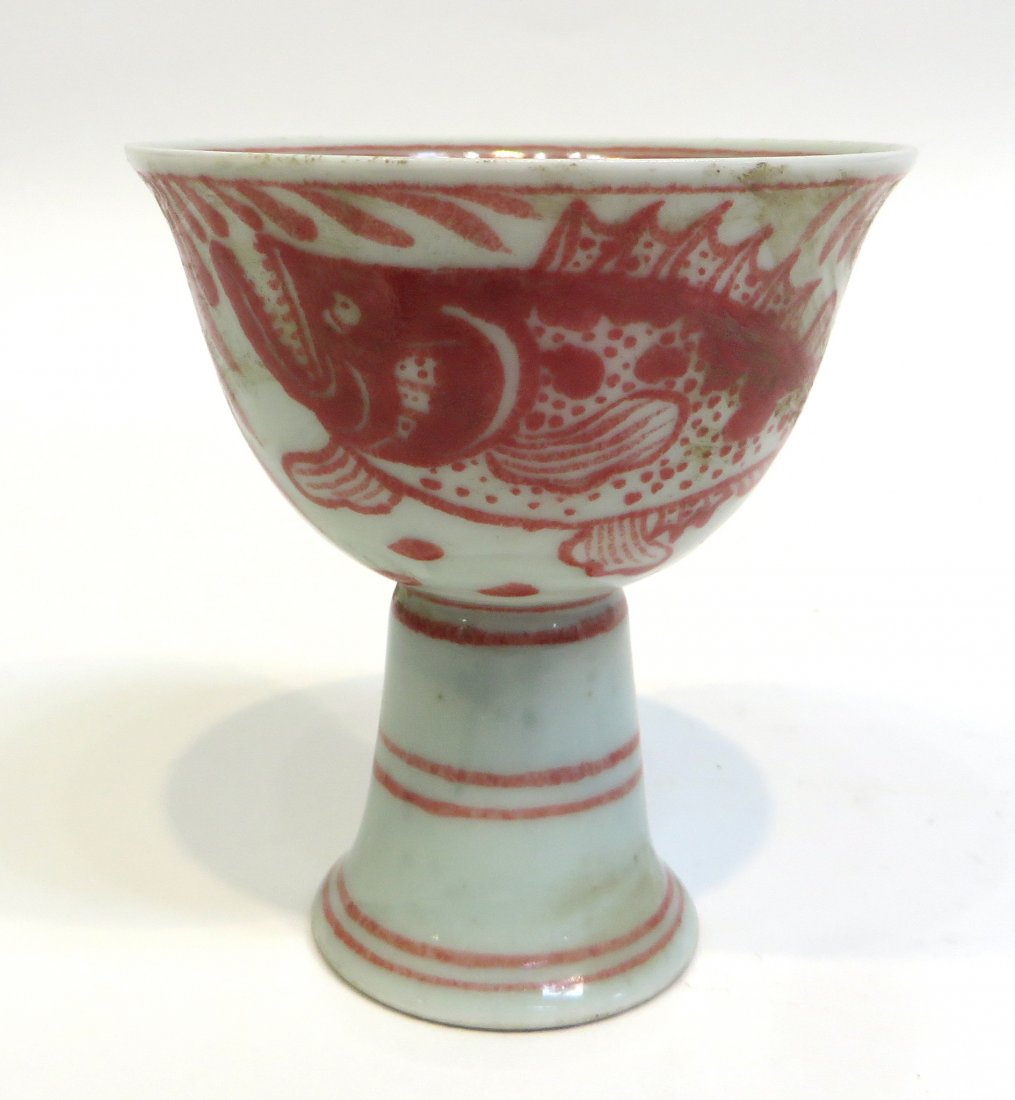 Chinese Porcelain High Heel Cup: At 3 3/4" tall, with an elevated base and a red glaze fish. Shipping: We are able to pack and ship this item to an address in the United States for $30.00 via USPS Priority Mail. Tracking information 