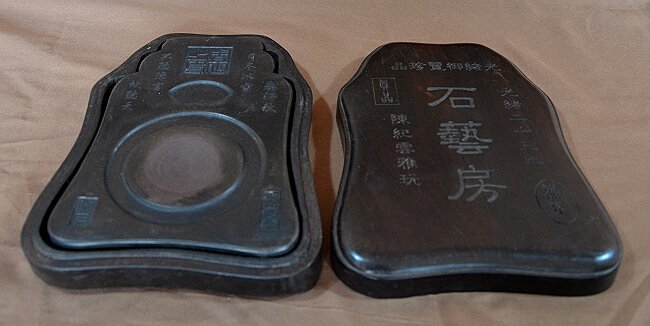 Carved Duan Inkstone: Duan ink-stone, carved Chinese character on Zitan box curved all around. About 9 1/2". Shipping: We are able to pack and ship this item to an address in the United States for $40.00 via USPS Priority 