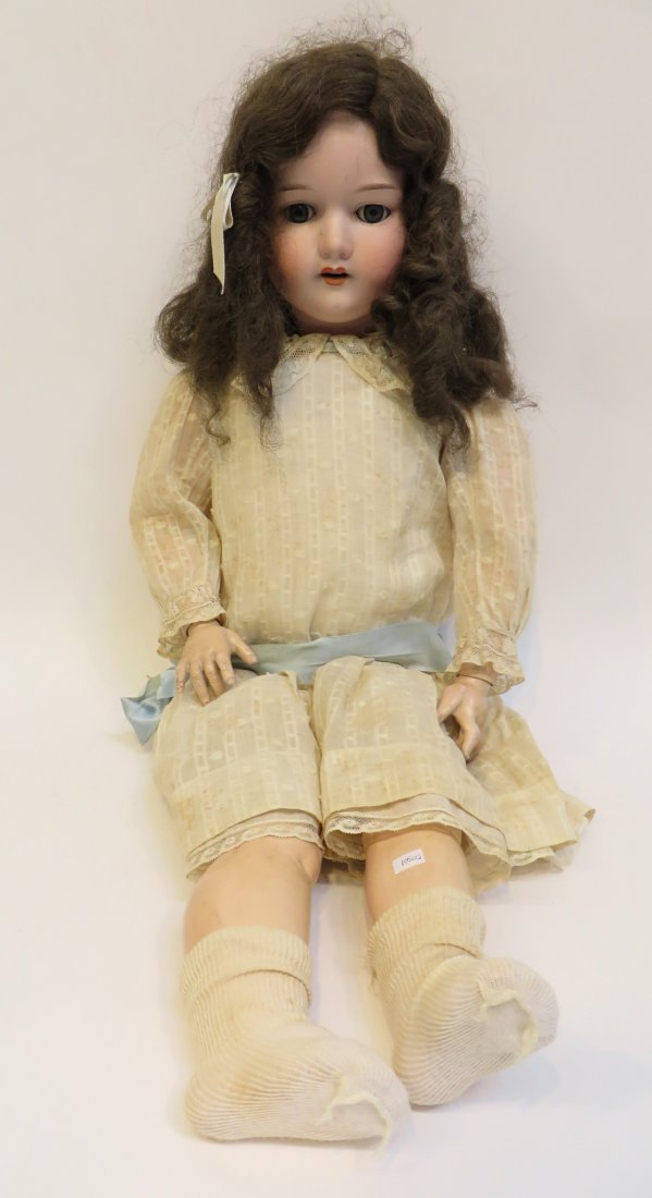 Annand Marseille German Doll: A larger 31" doll in early 20th century white garb, with embossed maker's marks on the back of the porcelain painted head. Jointed arms and legs. The rather Fragile white linen gown appears in excelle