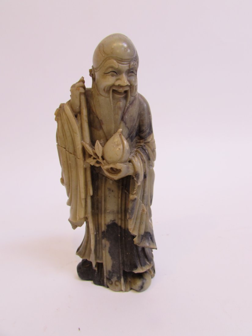 Chinese Louhan Figure: 7 1/8" in height of brown toned soapstone. Shipping: We are able to pack and ship this item to an address in the United States for $40.00 via USPS Priority Mail or via FedEx Ground/Home Delivery. Trac
