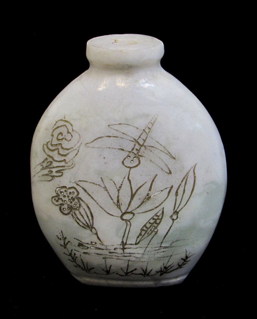 Hardstone Snuff Bottle: Engraved with gilt calligraphy and lotus/firefly scene in a cloudy milky white hardstone, possibly jade. 3 1/8", lacking stopper Shipping: We are able to pack and ship this item to an address in the U