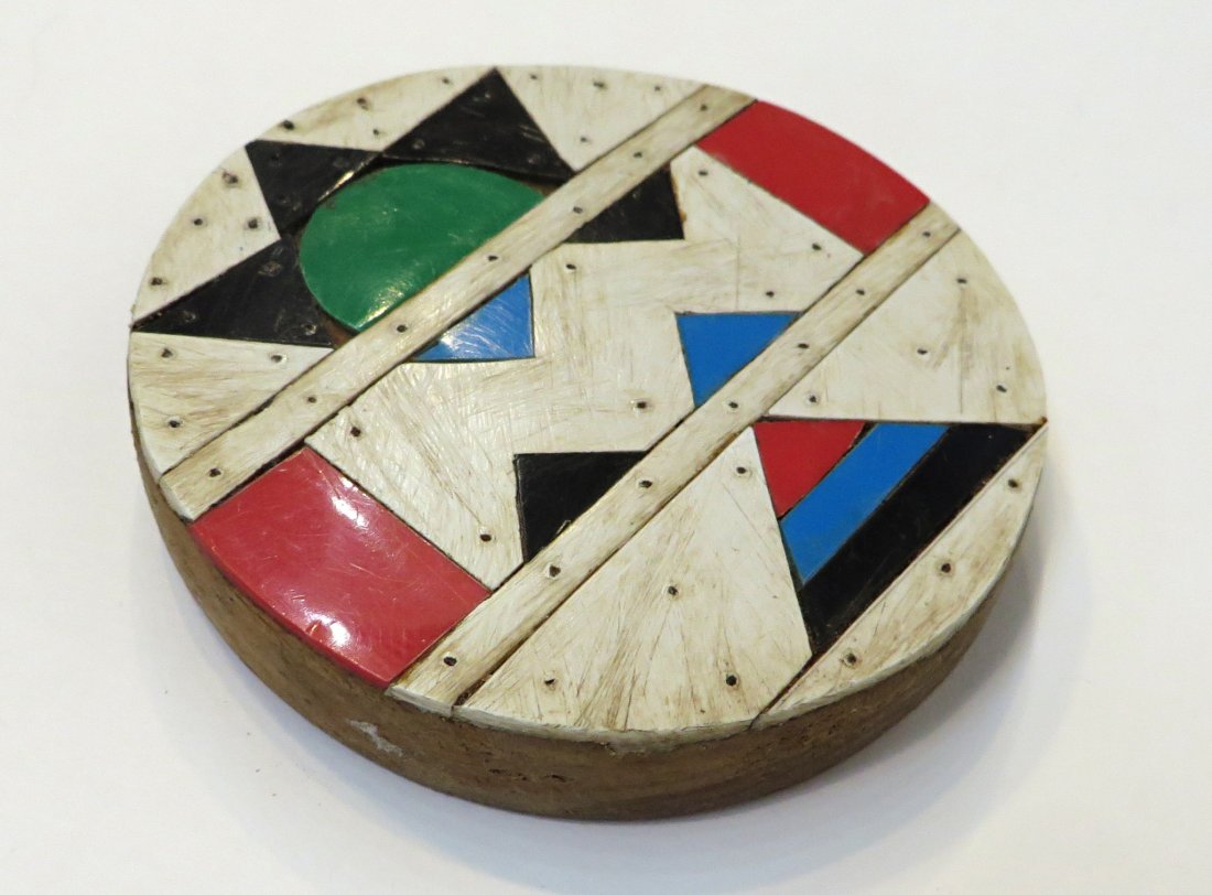 African Lip Plug: A 3 1/2" round plug with attached colored ivory zig-zag decorations. Shipping: We are able to pack and ship this item to an address in the United States for $15.00 via USPS Priority Mail. Tracking inf