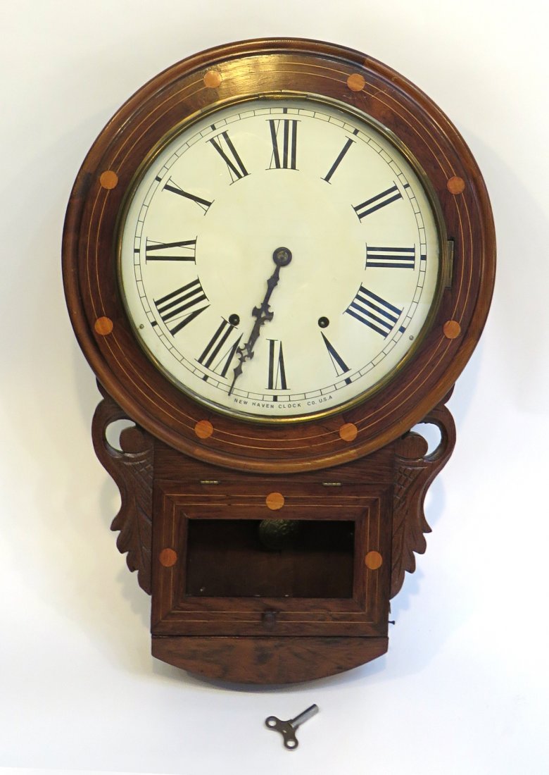 New Haven Wall Clock: A 24" Anglo-American wall clock featuring a dial signed "New Haven" (nicely restored) and striking eight day clock within a high quality inlaid case. Shipping: We are able to pack and ship this item t