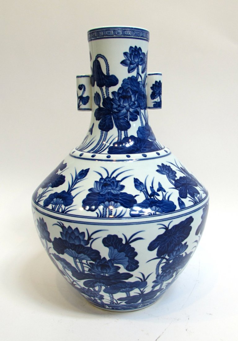 Blue And White Glazed Chinese Vase: With the Qianlong mark featuring Lotus flowers . 17 3/4" in height. hand painted Blue & White large vase. Shipping: We are able to pack and ship this item to an address in the United States for $55.00