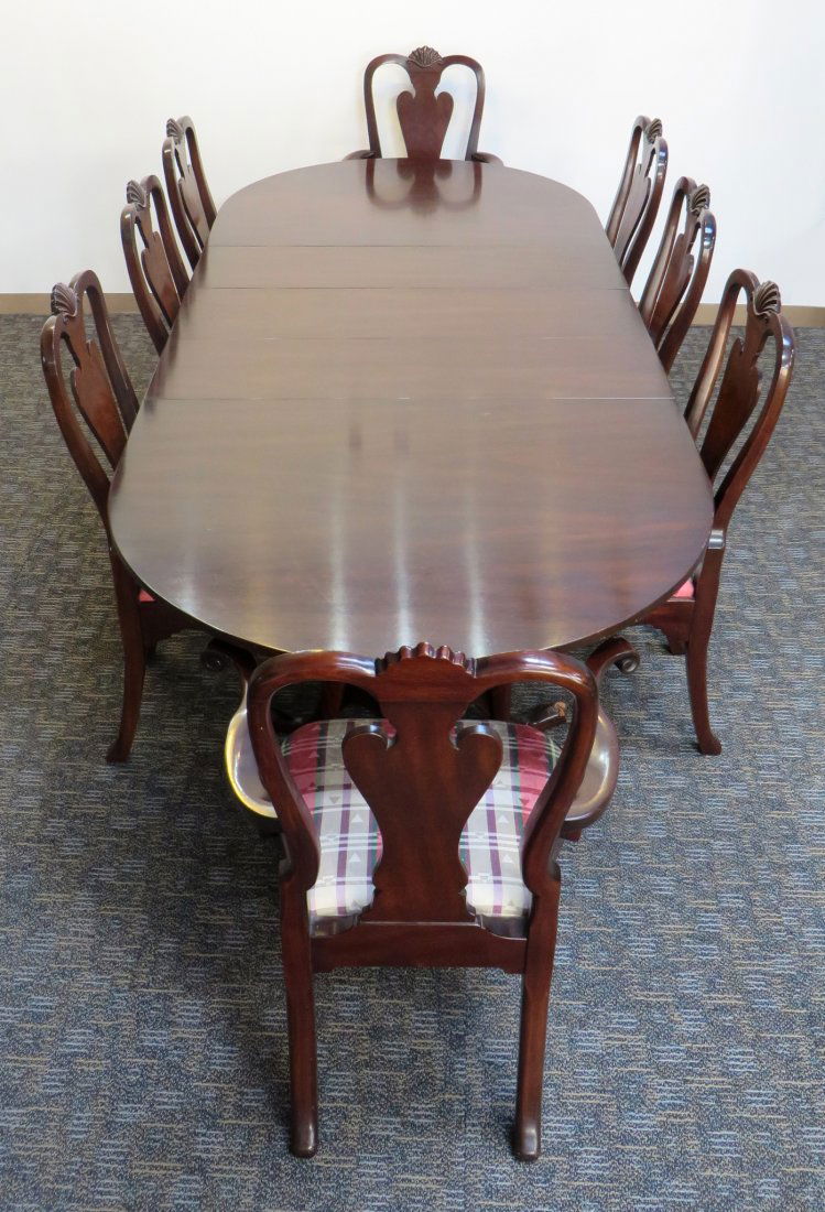 Diningroom Set: A solid mahogany pedestal style dining room table with demi-lune shaped ends and three extensions together with eight Queen Ann style matching mahogany chairs: two arm chairs, six side chairs, all wit