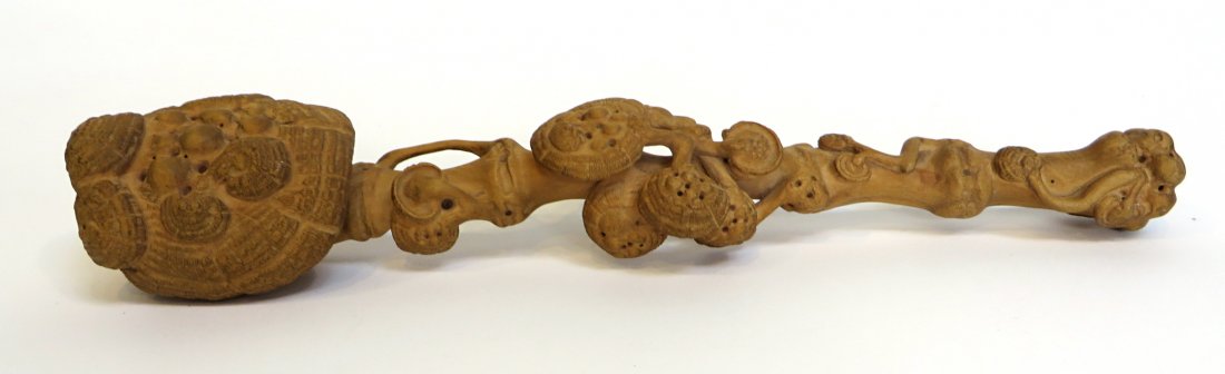 Carved Wood Ruyi: A 12 3/4" Ruyi carved from a single piece of wood. Shipping: We are able to pack and ship this item to an address in the United States for $40.00 via USPS Priority Mail or via FedEx Ground/Home Delive