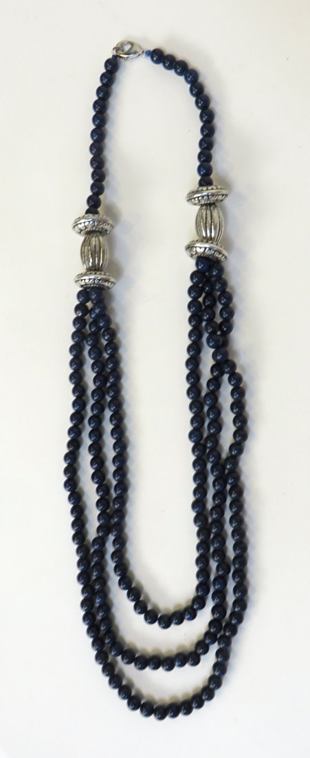 Lapis And Silver Tibetian Necklace: With beads about 5 mm in diameter strung in three rows below three piece silver devices, all leading to a one strand. The entire length about 22". Shipping: We are able to pack and ship this item to a