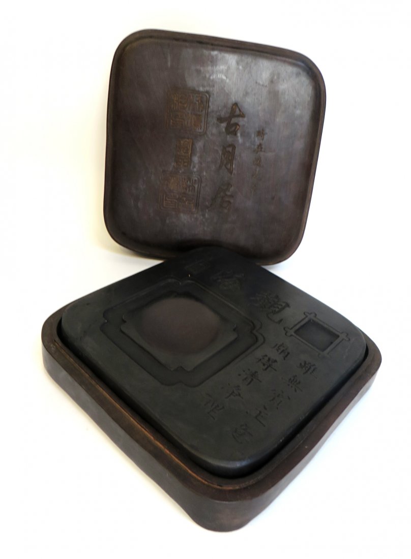 Inkstone In Case: With a square wood lidded case, rounded on the corners, 7 3/4" X 8". The reddish hued slate stone with incised imperfections. Shipping: We are able to pack and ship this item to an address in the Unit