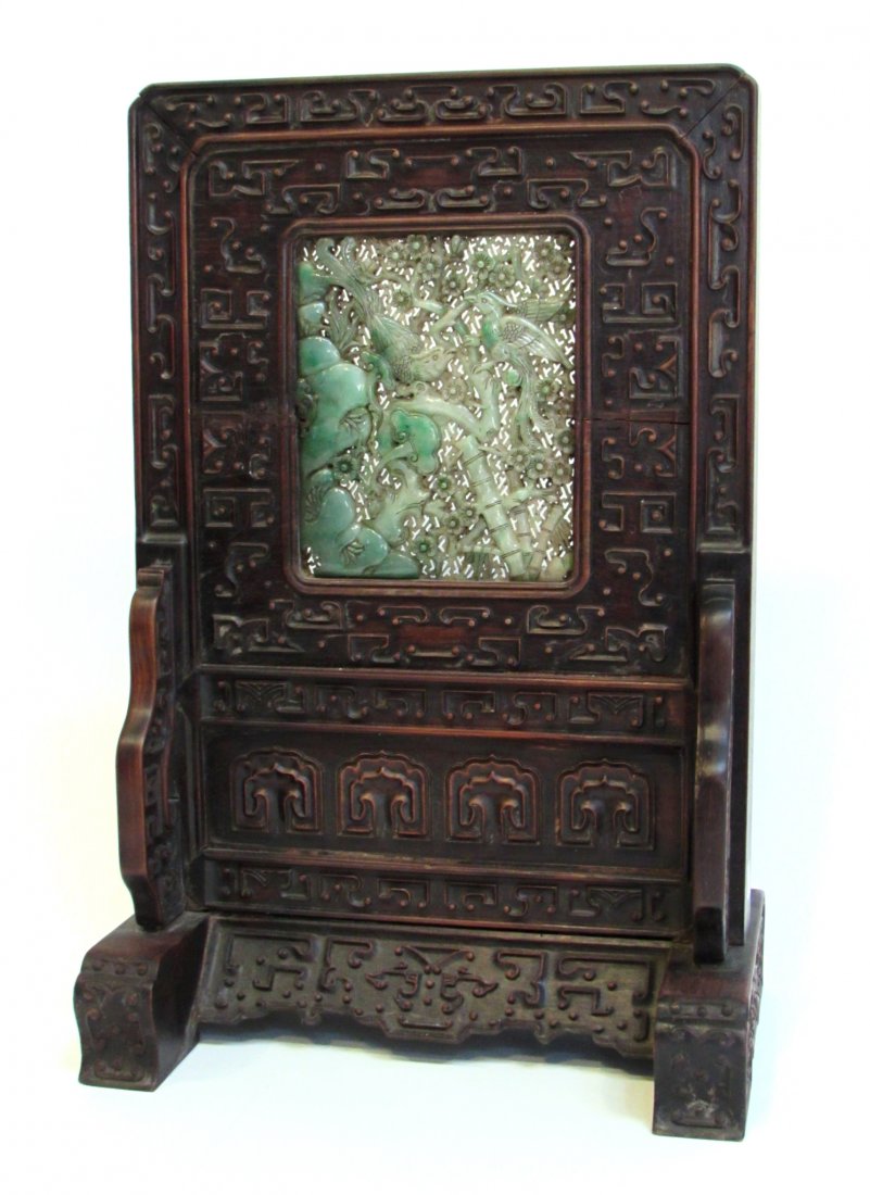 Chinese Qing Jade Mounted Screen: An important one piece screen, 18" in height. The rosewood base with fine bas relief carving and an inserted green and white Jade screen, 6" X 5". The jade of exceptional quality featuring a double pi