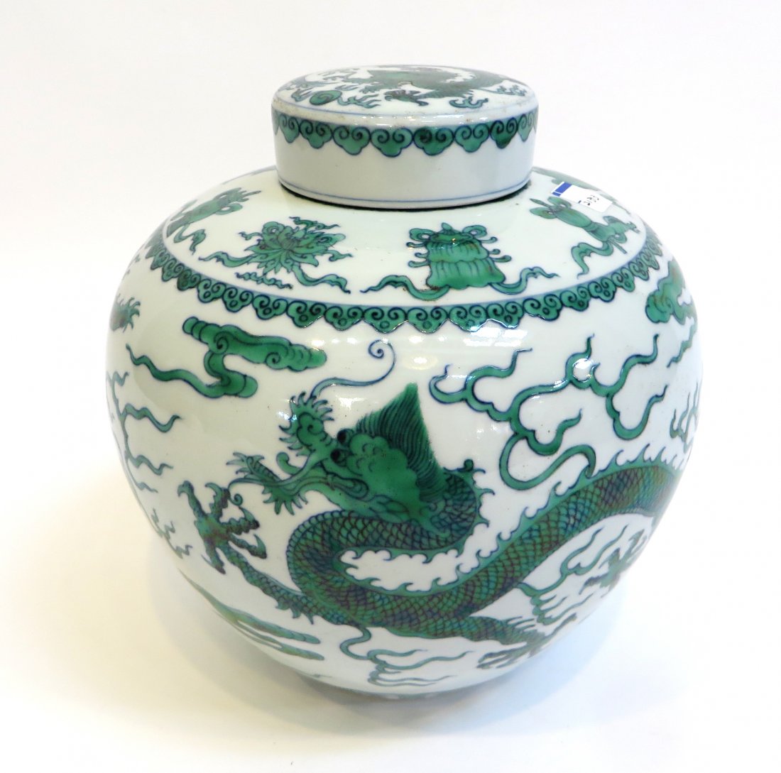 Lidded Dragon Jar: In verte green glaze, and 8" in height, images celebrating the five clawed dragons chasing flaming pearls. Qianlong mark on bottom. Shipping: We are able to pack and ship this item to an address in th