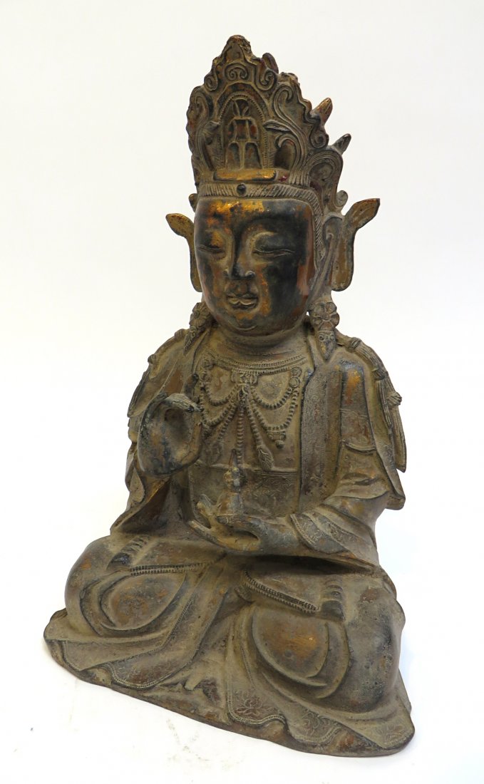Ming Dynasty Gilt Bronze Buddha: A Ming Dynasty gilt bronze Buddha with traces of gilt and lacquer surface. 12 1/2" tall. Shipping: We are able to pack and ship this item to an address in the United States for $50.00 via USPS Priorit