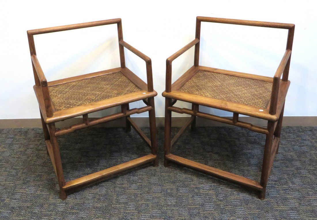 Pair Of Chinese Huang Hua Li Chairs: With caned seats, 34" x 24 1/2" x 19". High bidder takers the pair. Shipping: We are unable to ship this item. Please contact a third party shipper for a quote. Please be sure and include your shippin