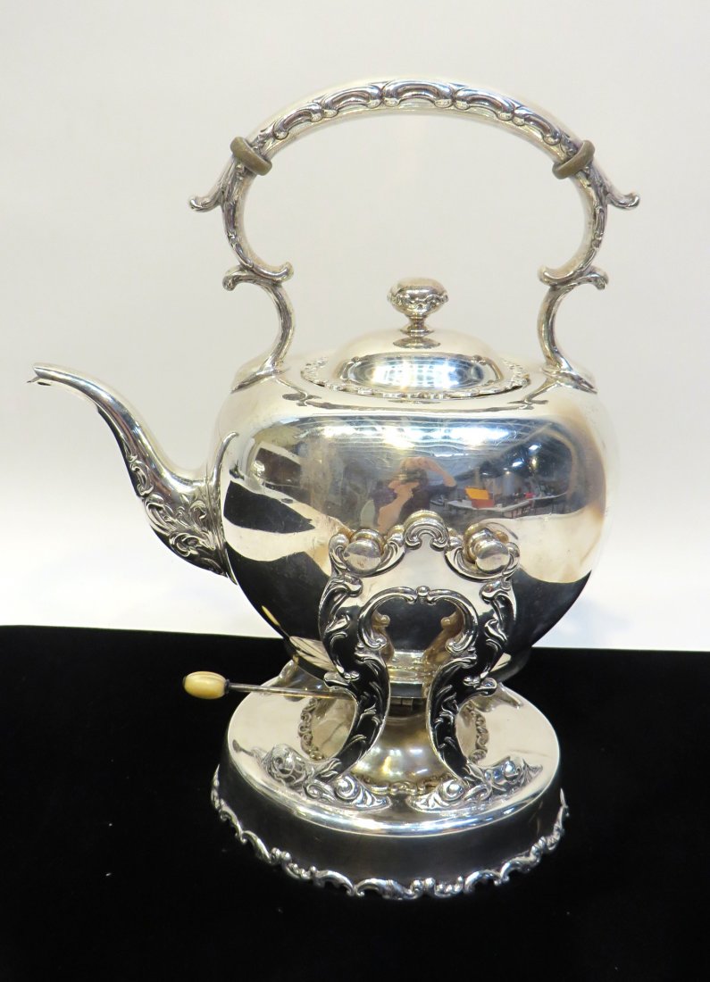 Sterling Tea Kettle: Standing 14" & 10" long, a tea kettle and frame together with the heater, all in sterling. 48.4 OzT. Shipping: We are able to pack and ship this item to an address in the United States for $50.00 via 