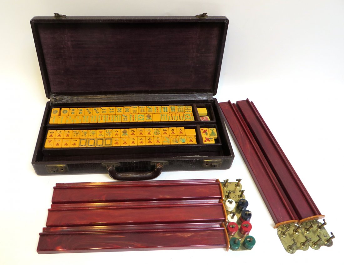 Mahjong Game: A mahjong game in a alligator leather carrying box. 19 1/2" x 9" x 3 1/2" Shipping: We are able to pack and ship this item to an address in the United States for $55.00 via USPS Priority Mail or via F