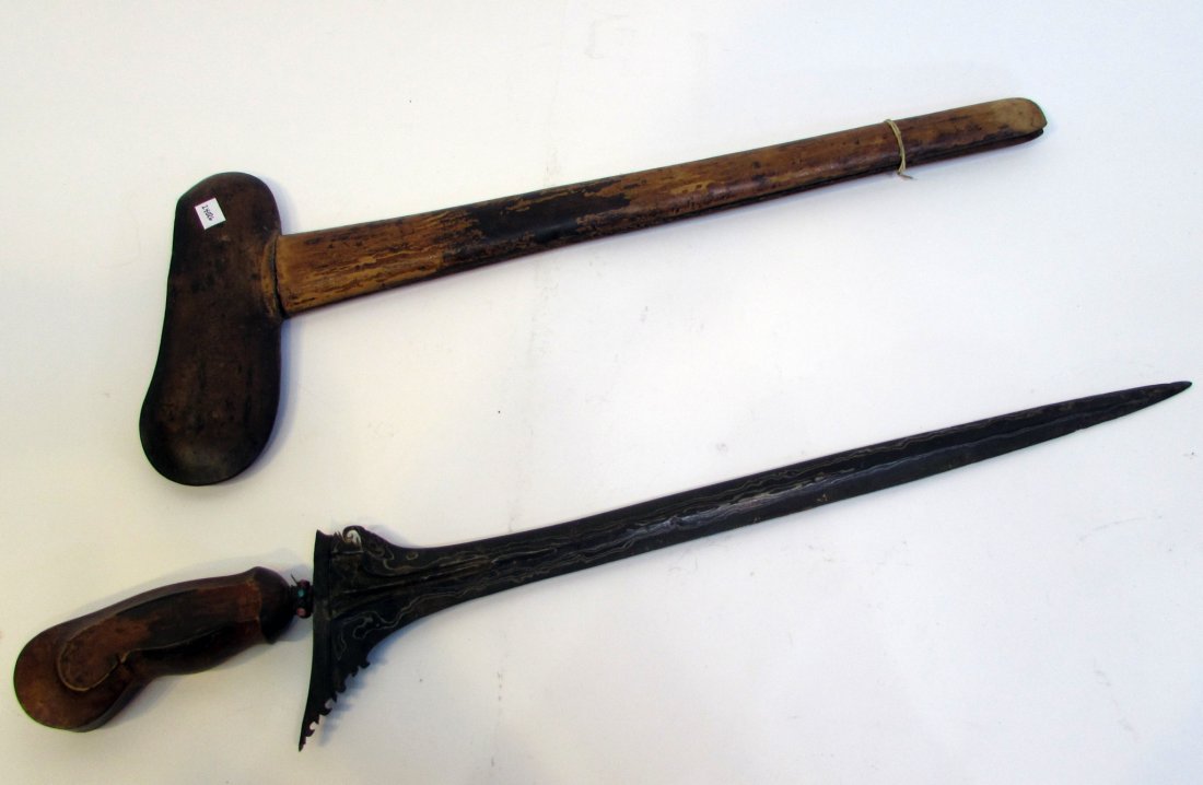 Sword: From an Indonesian collector, a sword and wooden sheath (24 1/2"), with a metal neillo like blade. Shipping: We are able to pack and ship this item to an address in the United States for $25.00 via US