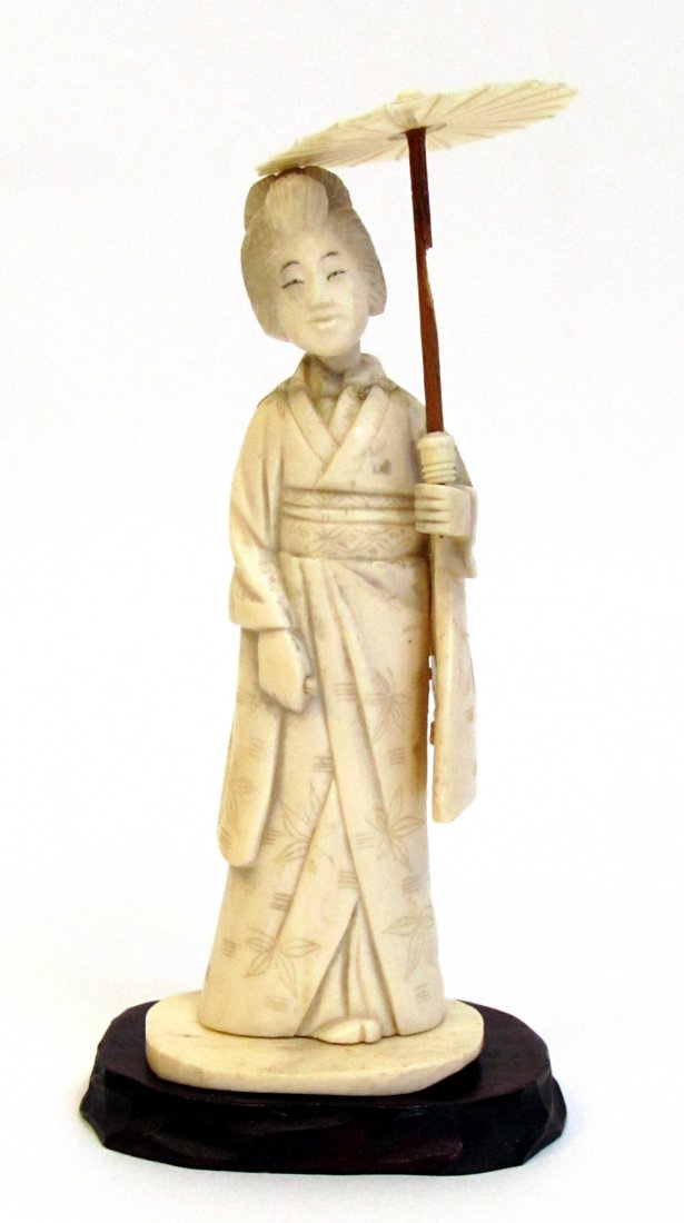 Figurine: With a signature cypher bottom of stand, repairs. In four pieces: the stand,carved ivory or bone stand, the figure, head and umbrella. About 4". Shipping: We are able to pack and ship this item to an 