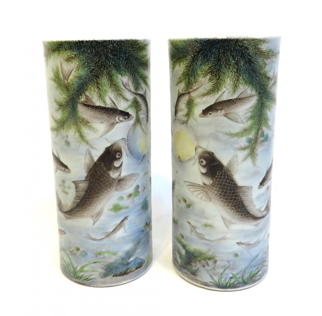 Pair Of 20th C. Hat Stands: A pair of 11" vases or hat stands, cylindrical and with numerous fish swimming in sea flora. 20th C. Mark on the bottom. Shipping: We are able to pack and ship this item to an address in the United St
