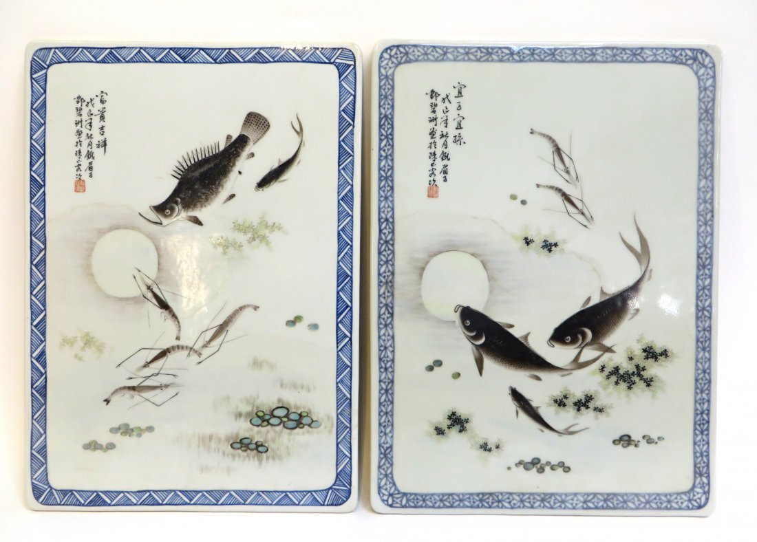 Porcelain Plaques: Two fish theme porcelain plaques, each 16 1/4" x 12 1/4" with various fish and shrimp swimming in the moonlight. Calligraphy on the upper left corner of both. Shipping: We are able to pack and ship th
