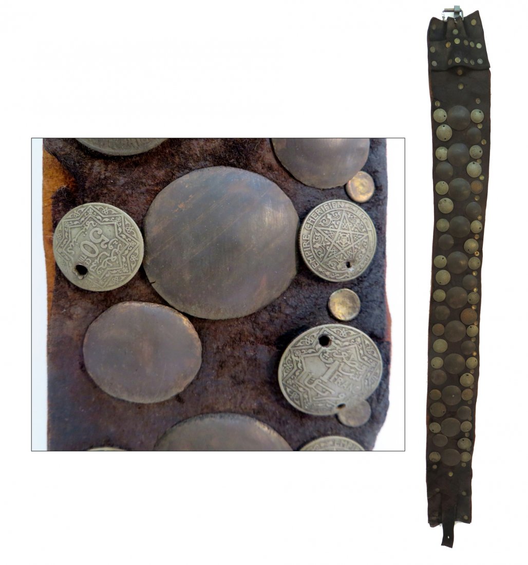 Tunisian Leather Belt With Mounted Coins: Tunisian Leather Belt With Mounted Coins: Description: With applied on coins and metal medallions. The belt is in worn condition. Dimensions: 40" lo