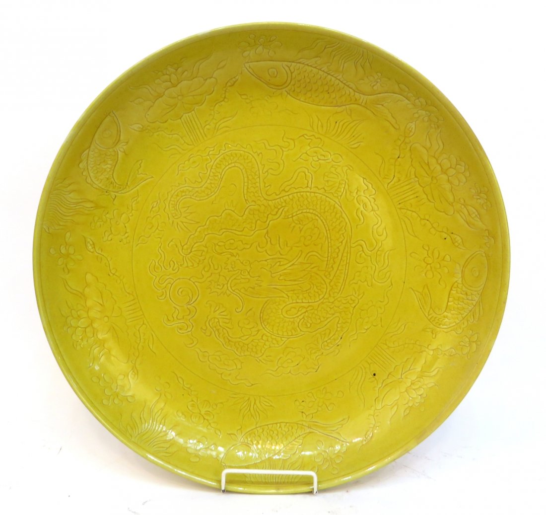 Yellow Glaze Dragon & Fish Charger: Yellow Glaze Dragon & Fish Charger: Description: Large yellow charger with incised dragon and pearl in the center, surrounded by fish and water lilies. Mark on the bottom.