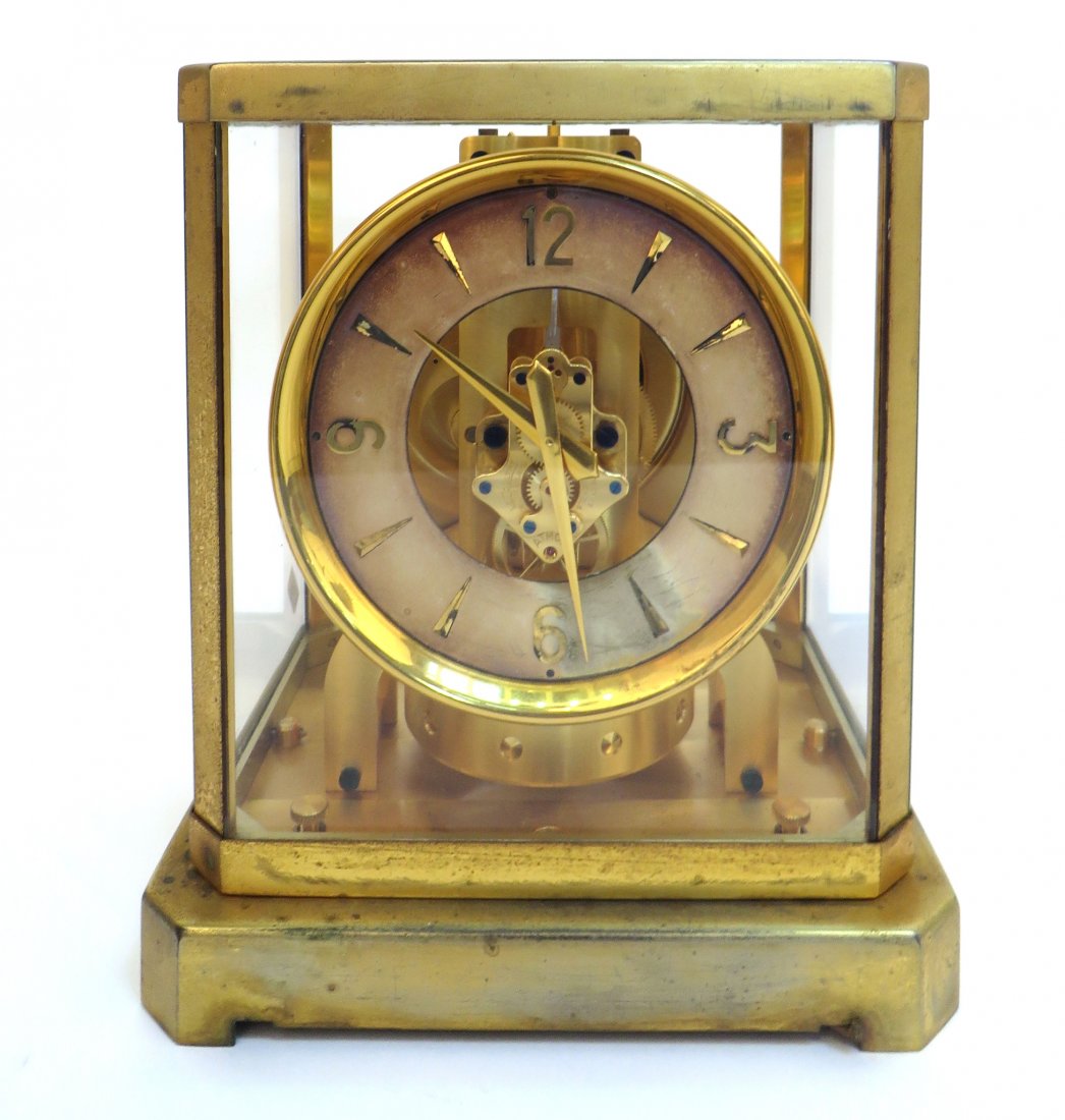 Atmos Clock: Atmos Clock : A gold toned and glass cased Atmos clock by LeCoultre of Switzerland, serial number 43,585. Circa 1960s. 9 1/4" X 8 1/4" X 6 1/2".