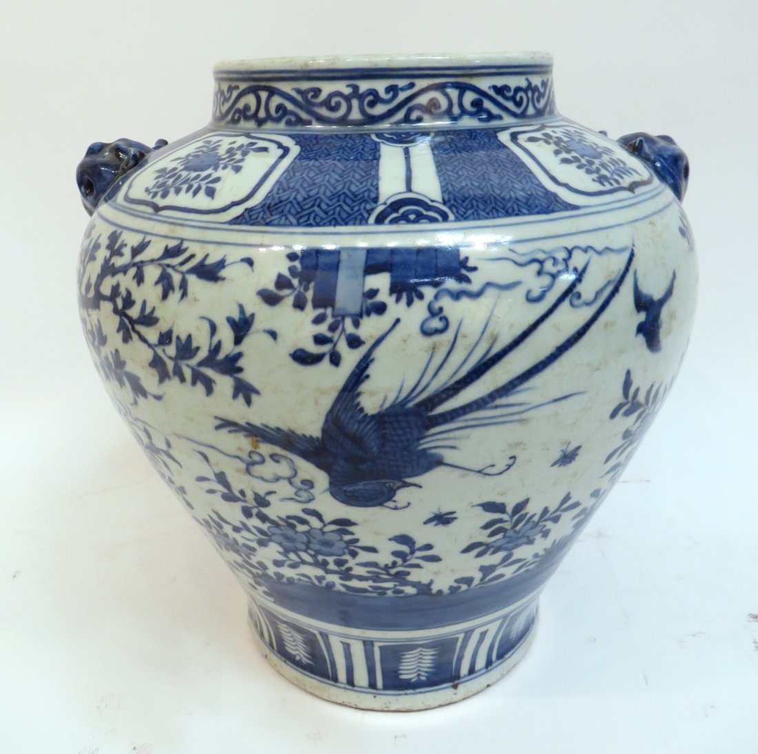 Ming Dynasty Blue And White Porcelain Jar: Ming Dynasty Blue And White Porcelain Jar: Ming porcelain jar in blue and white with scenes of birds and nature. Reserves of flowers set apart from a diaper pattern on the top portion. Trees, flower