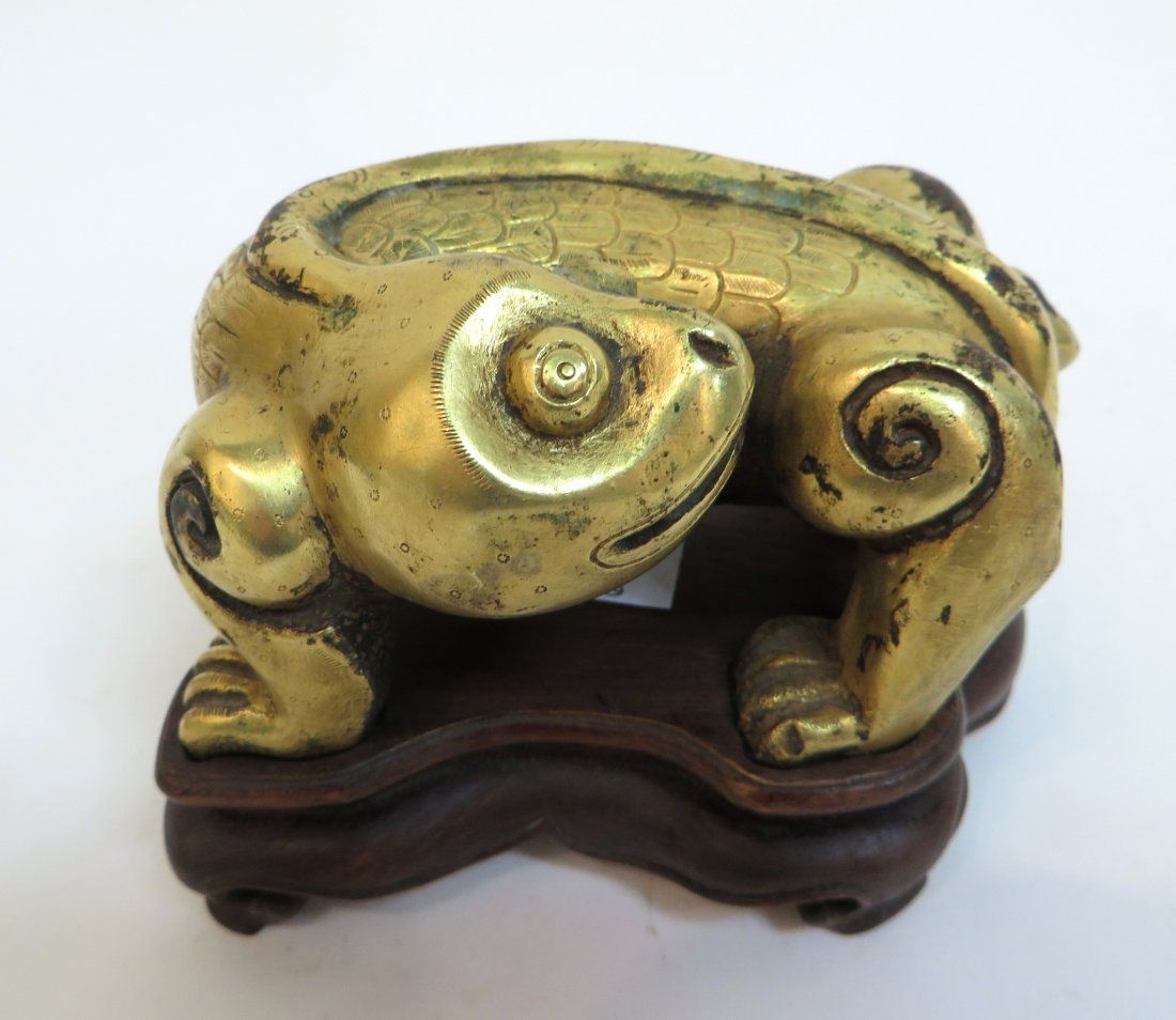 Han Dynasty Gilt Bronze Dragon On Stand: Han Dynasty Gilt Bronze Dragon On Stand: Small sculpture of a dragon looking behind. With gild gold surface, incised scales and long tail. Hollow cast on custom stand. 4 1/