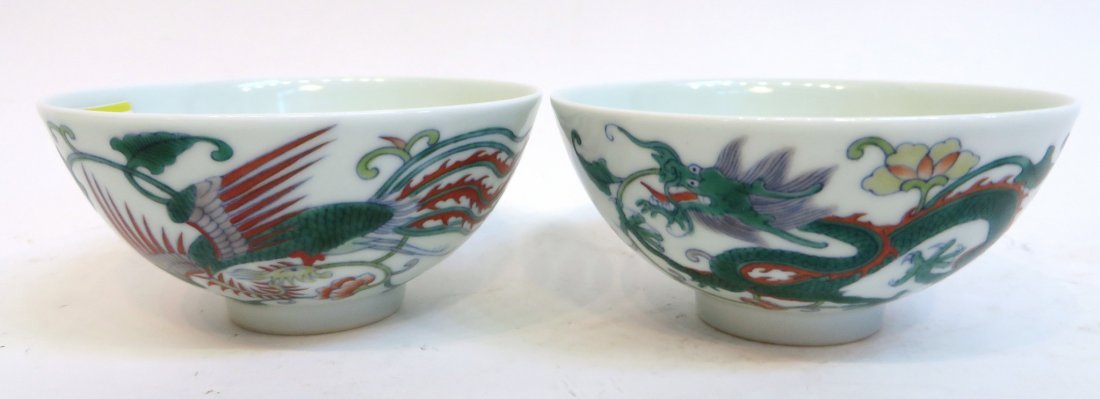 Pair Of Yongzheng Dragon Phoenix Porcelain Bowls: Pair Of Yongzheng Dragon Phoenix Porcelain Bowls: A pair, each with stylized dragon and phoenix designs. Calligraphy on reverse side. Six character mark on the bottom. 4 1
