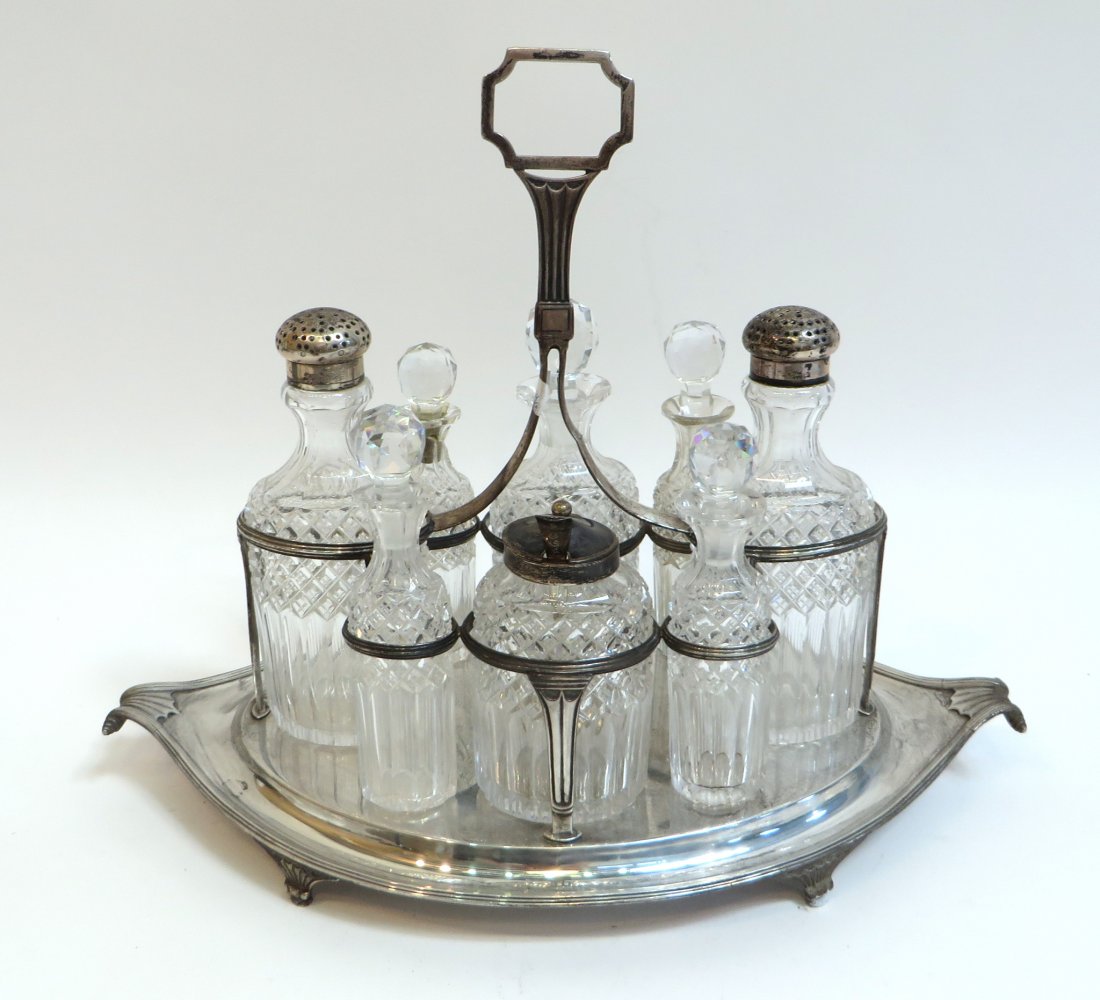 Sterling And Crystal Vinegar Cruet Set: Sterling And Crystal Vinegar Cruet Set: A hallmarked silver frame encloses eight crystal bottles. Some bottles have sterling screw-on tops, the rest have crystal stoppers. Note repair to one bottle n