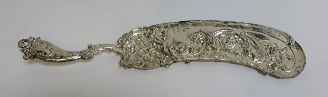 Sterling Fish Knife: Sterling Fish Knife: A sterling fish knife featuring a scene of a fairy playing pipes under a tree. Hallmarked on the front. 118g. 12" $100 - $200 Ship