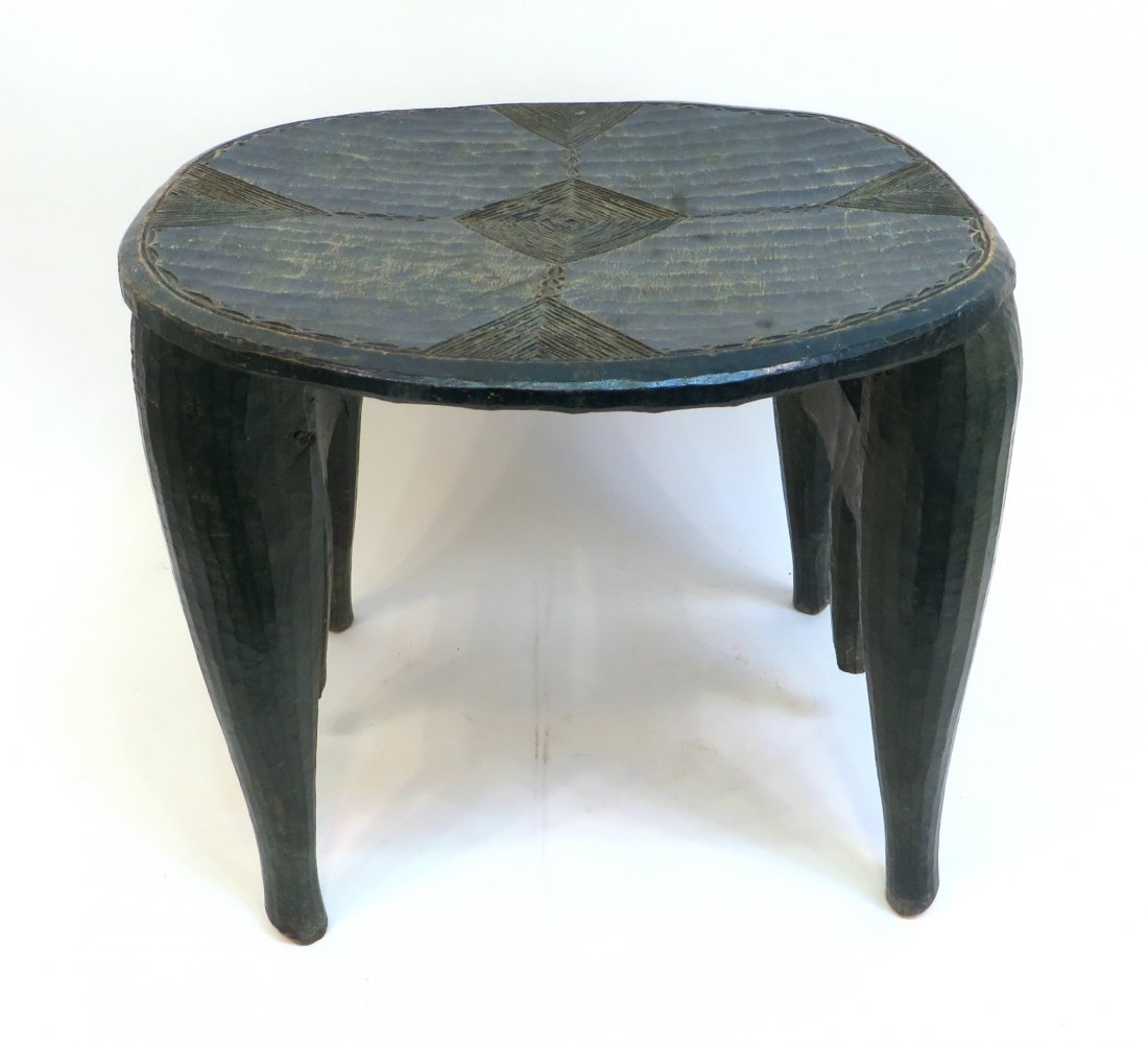 African Painted And Carved Low Table: African Painted And Carved Low Table: A 19th Century carved hardwood table on tapered legs, the top carved and incised in a geometric pattern with blue/purple paint. 16&quo
