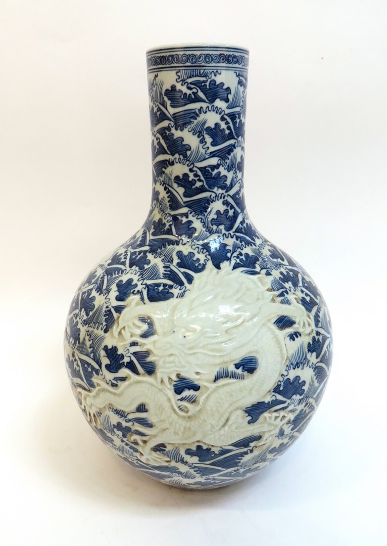 Chinese Emboss Decorated Dragon Vase: Chinese Emboss Decorated Dragon Vase: With Qianlong mark. 15" tall, 10" wide $200 - $400 Shipping: We are able to pack and