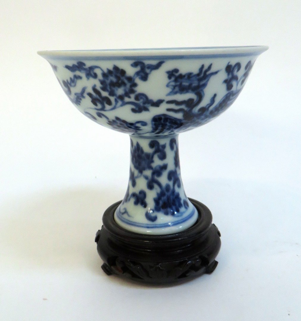 Blue & White Ming Wine Cup On Stand: Blue & White Ming Wine Cup On Stand: Blue and white high heeled cup on stand decorated with two phoenixes flying among flowers. Marked on the inside. Bottom of the cup is solid.
