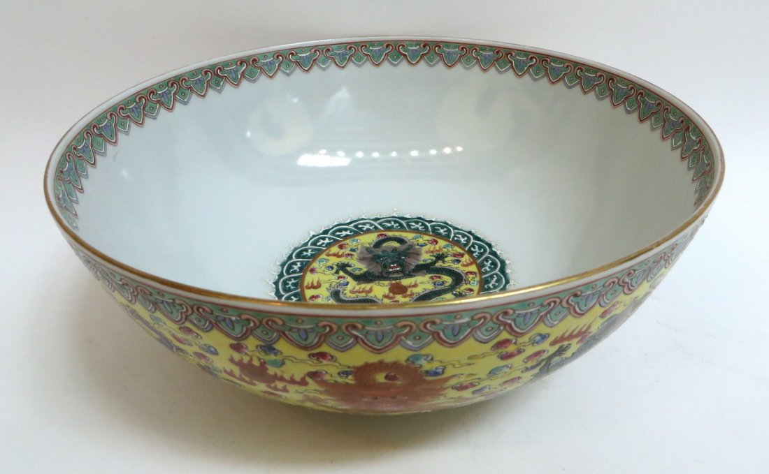 Qianlong Enamel Glaze Dragon Bowl: Qianlong Enamel Glaze Dragon Bowl: Against yellow glaze, the exterior surrounded by nine dragons of striking colors. The central interior medallion with a dragon and flaming pearl among a stylized wa