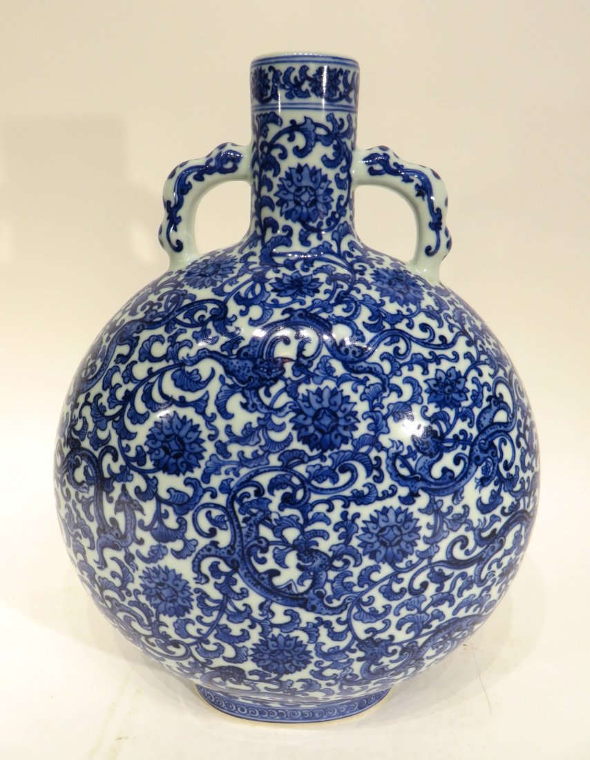 QIAN LONG MARKED BLUE AND WHITE MOON FLASK: Qian Long Marked Blue And White Moon Flask: Thick potted vase of tapered globular body, with narrow straight neck to the rim, raised on splayed footed oval base. Finely painted in cobalt blue depicti